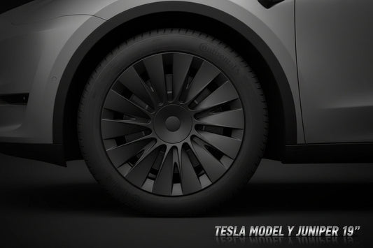 Close-up of a car wheel with a black rim and tire on a vehicle.