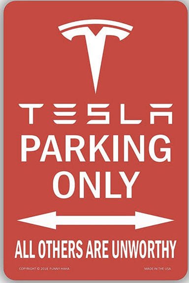 Red sign with Tesla logo and text 'Tesla Parking Only, All Others Are Unworthy' on a white background